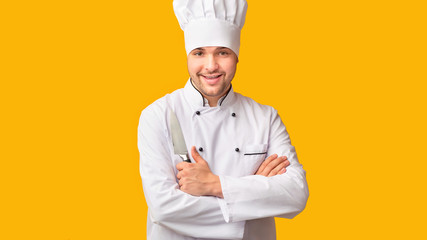 Professional Chef Posing Holding Kitchen Knife, Yellow Background, Panorama