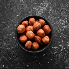 Obraz premium Hazelnuts in a bowl. Nut. Top view.