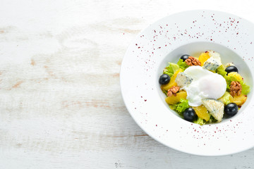 Salad with vegetables, blue cheese, olives and nuts. Vegetable salad. Top view. Free copy space.