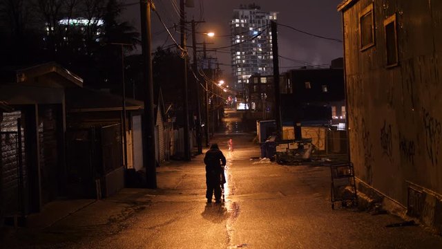 Wet and Dirty Alley with Homeless Man Pushing Cart