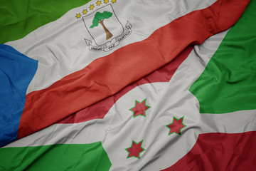 waving colorful flag of burundi and national flag of equatorial guinea.
