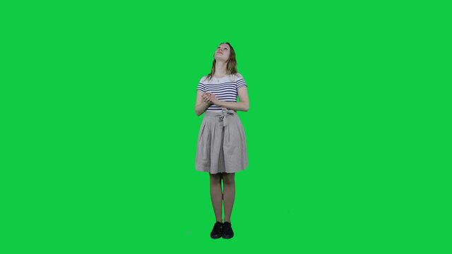 Cute teenage girl dreaming in front of a green screen