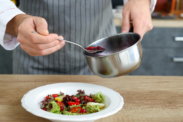 Male chef cooking in kitchen, closeup