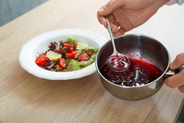 Male chef cooking in kitchen, closeup
