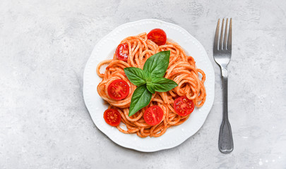 pasta spaghetti with tomatoes and basil.  traditional dish of Italian cuisine. pasta recipe