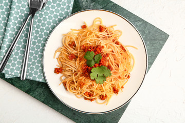 Plate with tasty pasta bolognese on white background