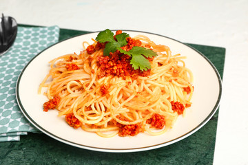 Plate with tasty pasta bolognese on white table