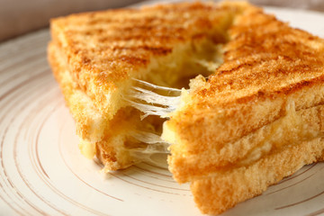 Tasty sandwiches with cheese on plate, closeup