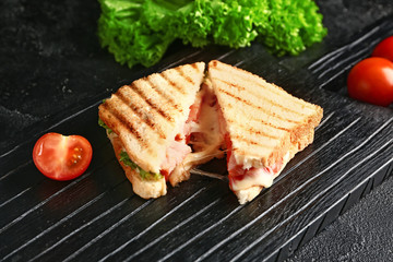 Tasty sandwiches with cheese on dark background