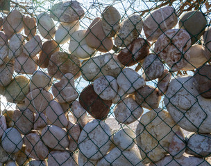 Fence made of stones and mesh