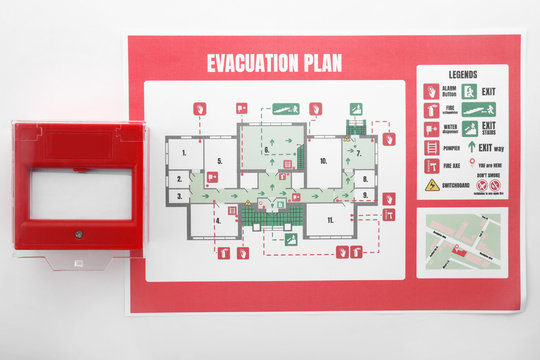 Evacuation plan and manual call point on white background