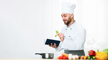 Man Learning To Cook Reading Recipe Book In Kitchen, Panorama