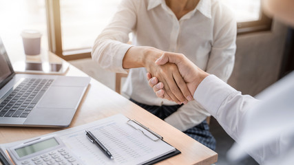Business partnership hand shaking successful commerce dealing.