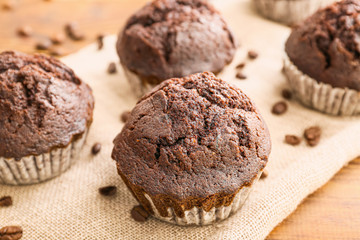 Tasty chocolate muffins on table