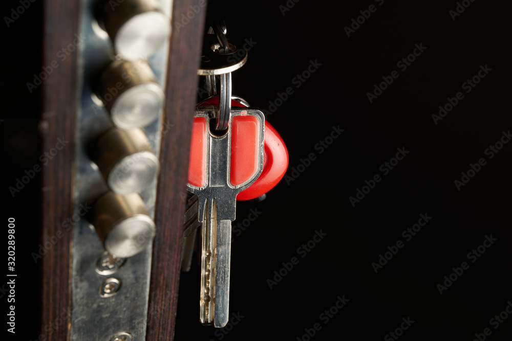 Poster the door lock with the handle and a key. focus on keys