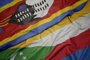 waving colorful flag of comoros and national flag of swaziland.