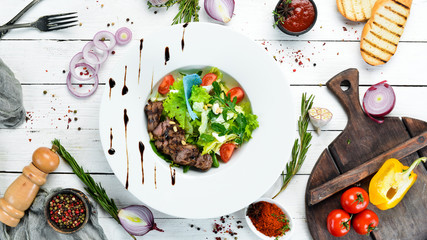 Vegetable salad with veal. Lettuce, veal, pine nuts, cherry tomatoes. Top view. Free space for your...