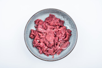 Fresh beef slices on a plate on white background