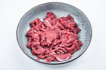 Fresh beef slices on a plate on white background