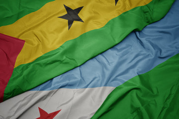 waving colorful flag of djibouti and national flag of sao tome and principe .