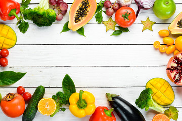 Set of fruits and vegetables on white wooden background. Food background. Top view. Free space for your text.