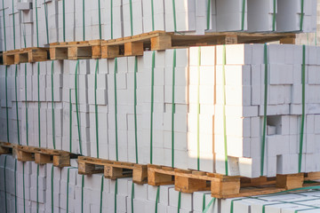 Construction Materials. Building materials for construction of residential complex. Pile of white bricks at construction site