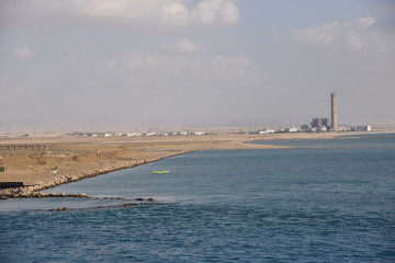 Landscape of the south entry to the Suez Canal. View from transiting cargo ship. 