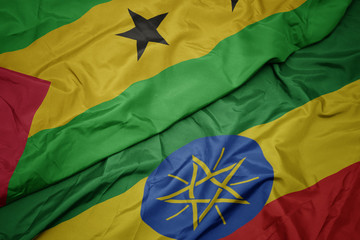 waving colorful flag of ethiopia and national flag of sao tome and principe .