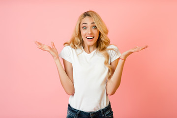 Joy. Surprised woman raising hands and looking at camera
