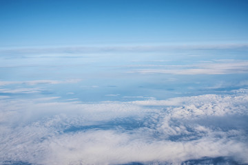 Blue cloudy sky, view from the airplane window. Aerial view of cloudscape