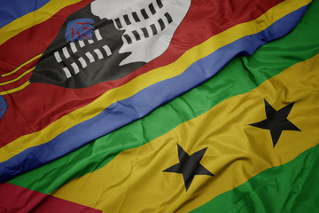 waving colorful flag of sao tome and principe and national flag of swaziland.