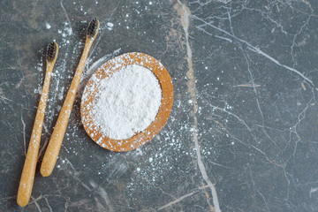 bamboo eco friendly toothbrushes and tooth powder, zero waste tooth cleaning set on dark marble ...