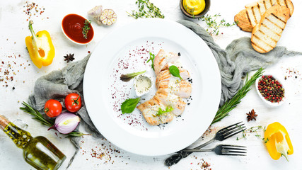 Baked chicken fillet with cream sauce. Top view. Free copy space.