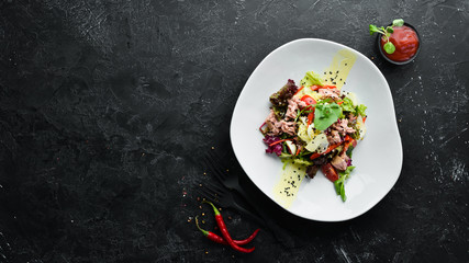 Vegetable salad with tuna and quail eggs. Food. Top view. Free space for your text.