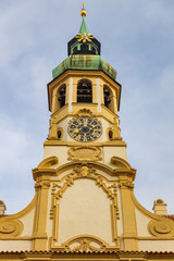 Clock tower of famous historical Loreta building in Prague, Czech Republic