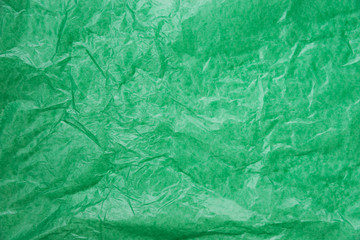 abstract background green crumpled transparent paper on white paper.