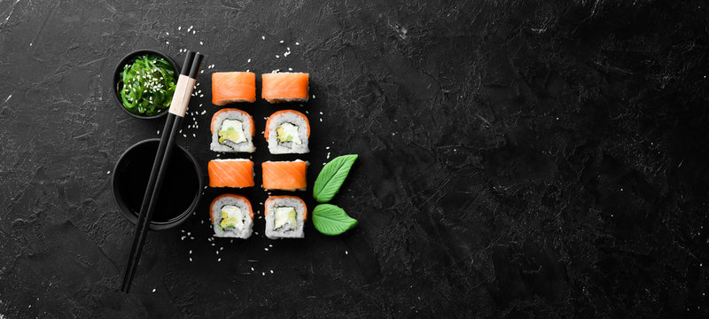 Philadelphia sushi roll with salmon and avocado. Japanese Traditional Cuisine. Top view. Rustic style.