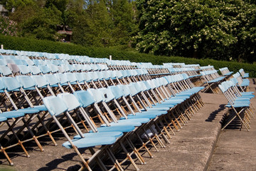 Rows of folding chairs ready for an outdoor audience