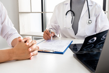Fototapeta premium Female doctors, specialists in treatment, make an appointment to meet patients after x-ray and give advice, explain medical information and diagnose the disease. Concept of treatment and good health