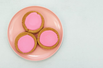 Traditional Dutch pink glazed cakes on a plate.