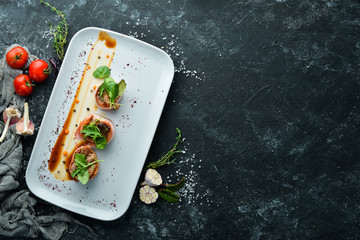 Veal medallions. Veal baked in bacon on a plate. Top view. Free copy space.