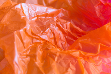Close up wrinkled orange paper is beautiful. Selective focus with blurred background.