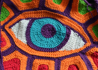 Eye-crocheted colorful background, freeform style, blue eye illustration
