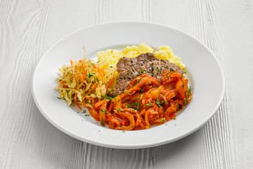 Plate with chopped meat baked with bell pepper with mashed potato and cabbage salad