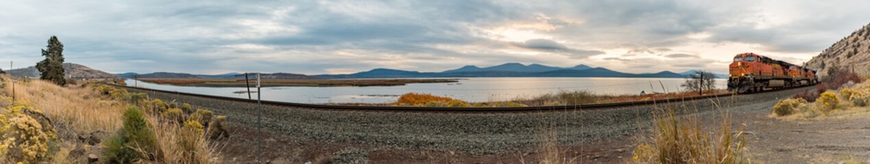 Panoramic view of a train track and locomotive approaching Klamath Falls