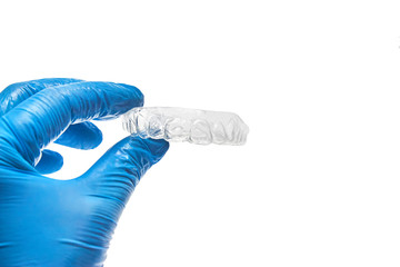 Hand holding individual dental tray for bleaching teeth Isolated on a white background