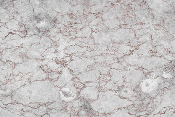 Texture of the aged surface of gray-pink marble.