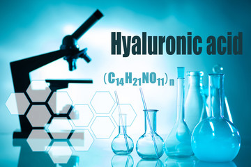 Chemical utensils and microscope on a blue background. Conducting research under a microscope. We learn from our own experience. Medical laboratory. Assessment of the quality of raw materials.