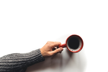 red coffee cup in hands on white background