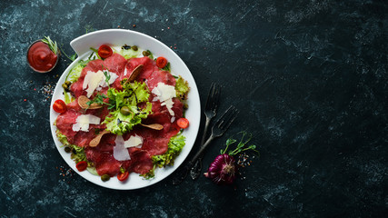 Veal carpaccio. Veal with capers and parmesan cheese. Top view. Free copy space.